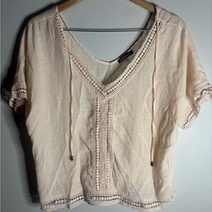 Soft Pink draped top,  detailed trim on the bottom, sleeve’s and V neck .